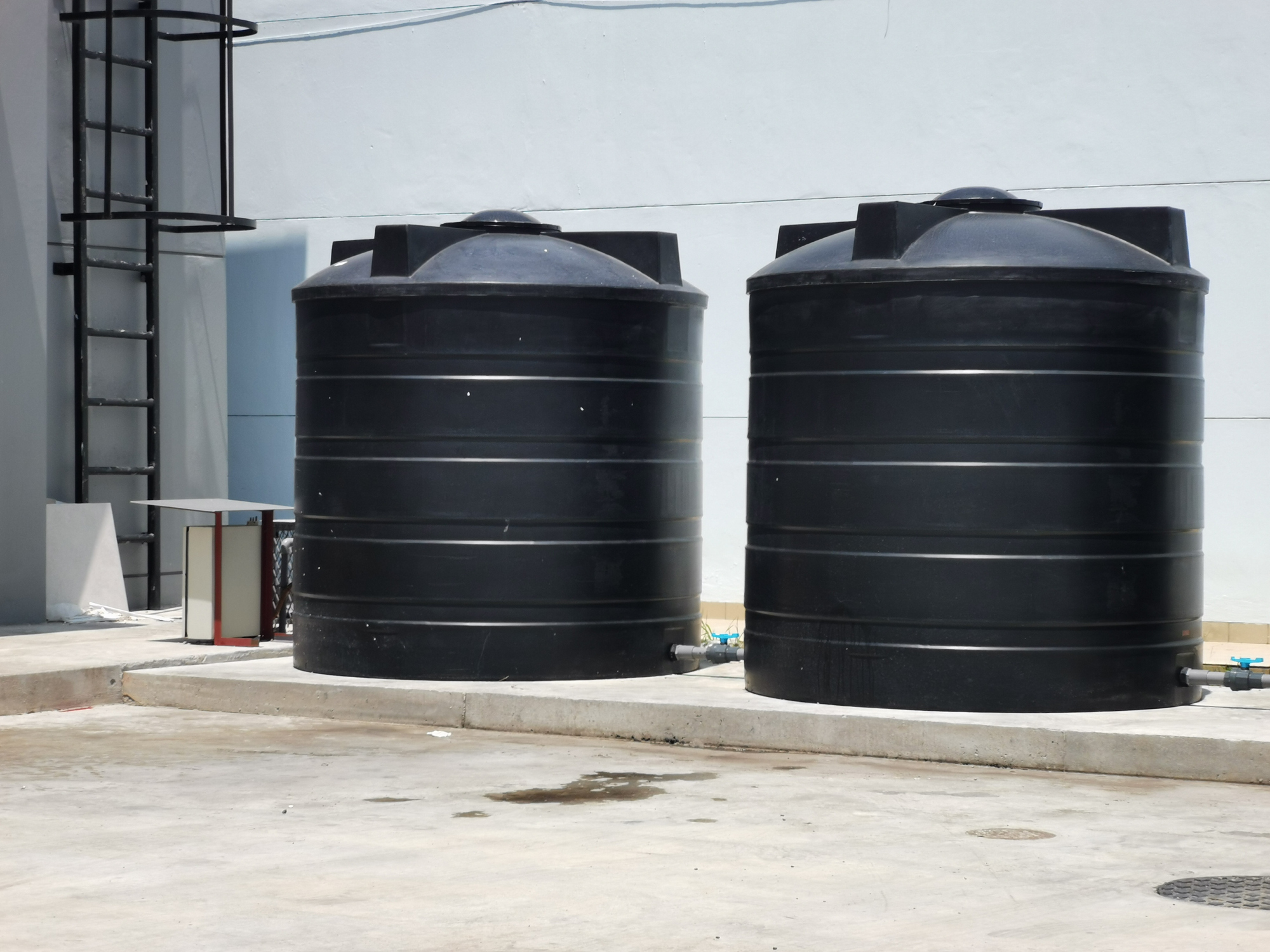 Image of black water tank of industrial building.