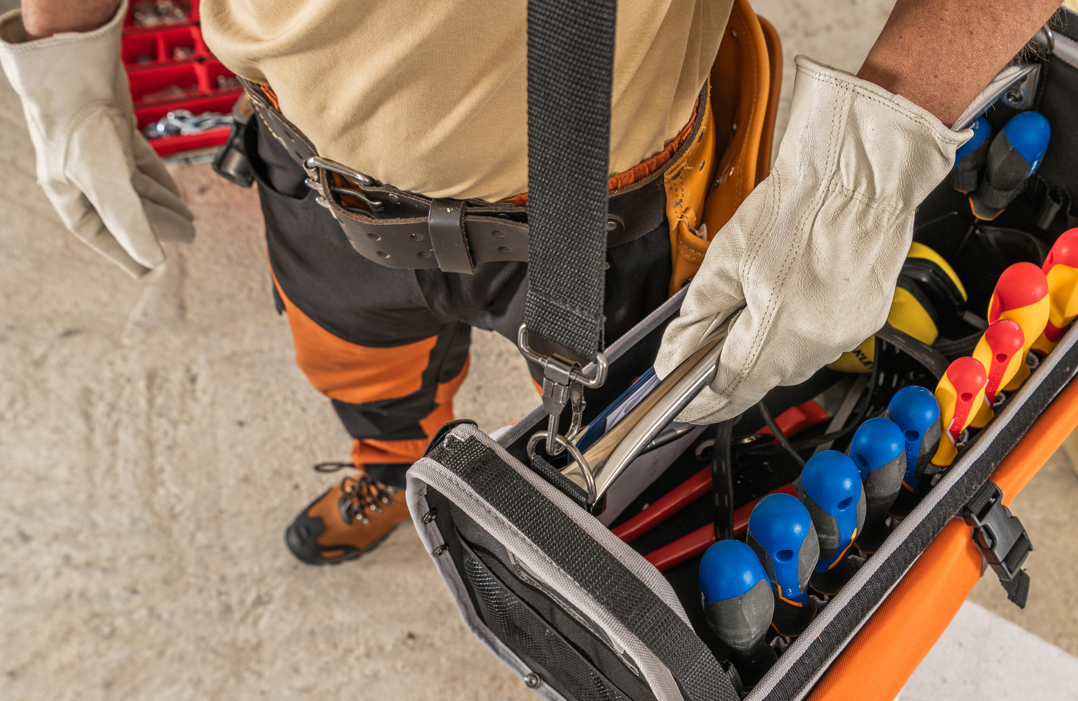 Construction Worker Moving with a Tool Box Hanged on His Shoulder