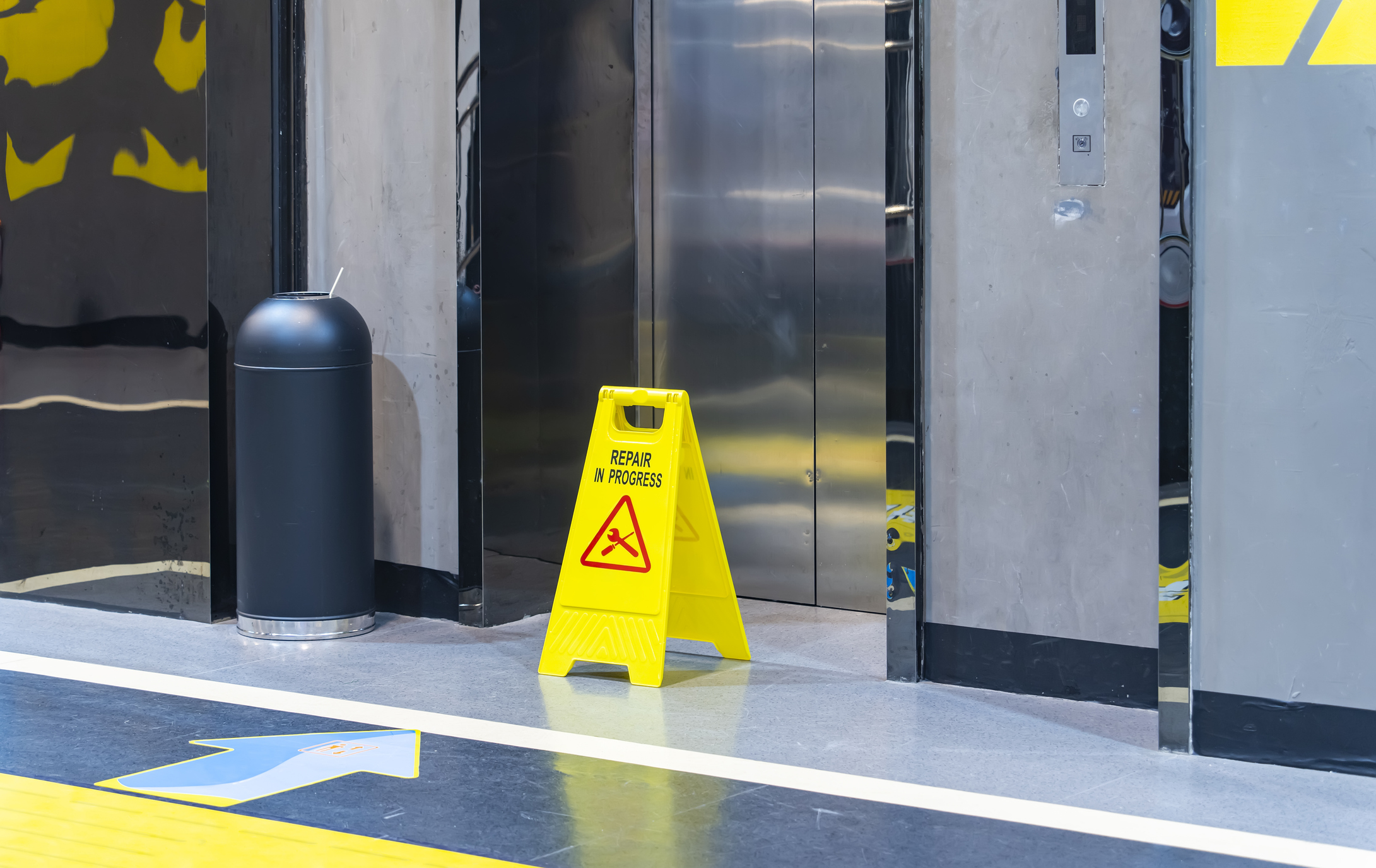 repair in progress sign near an lift, warning sign