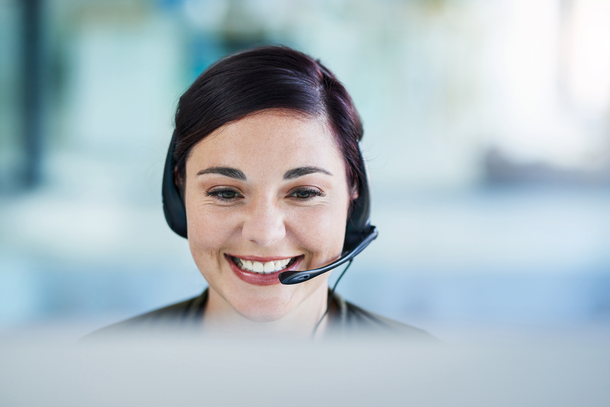 Shot of a young call centre agent working in an office